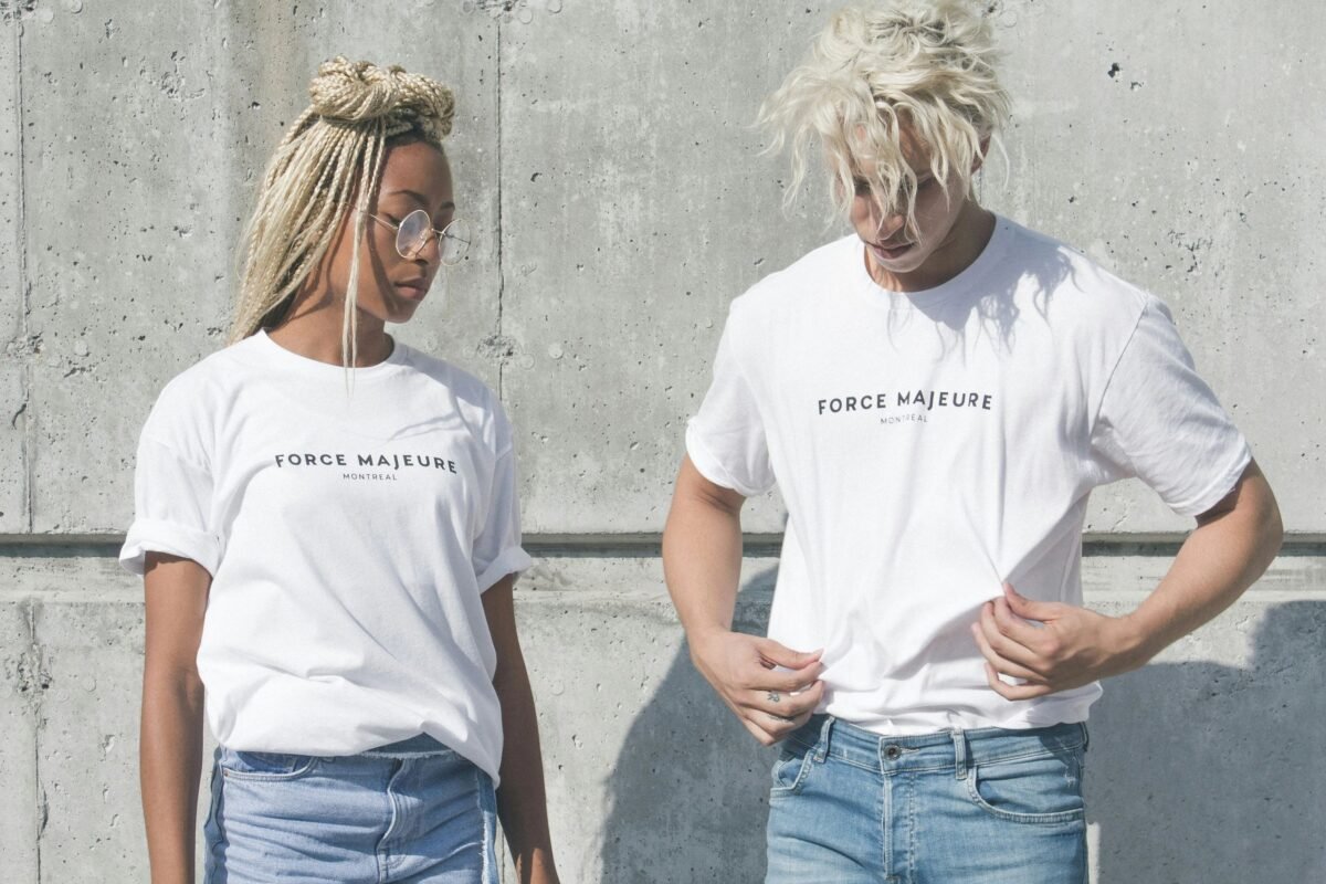 Image: A man and woman wearing white T-shirts, standing together.