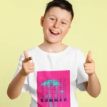 Boy wearing a summer graphic t-shirt with a vibrant beach-themed design