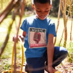 Boys' music-themed t-shirt featuring 'For the People, By the People' design in bold colors