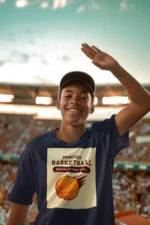 Boy wearing a blue practice basketball t-shirt, dribbling a basketball on an outdoor court.