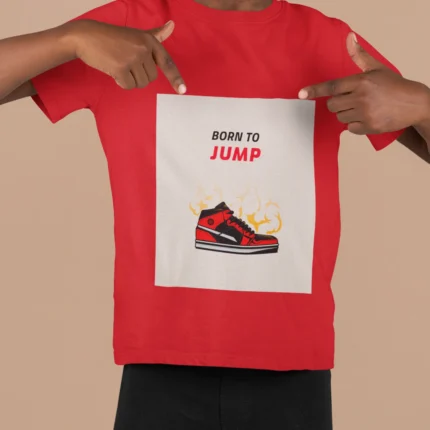 A boys' t-shirt with the bold graphic "Born to Jump" printed on the front, showcasing vibrant colors and a dynamic design.