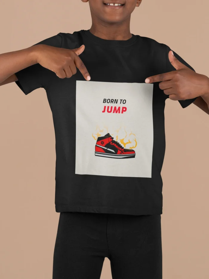 A boys' t-shirt with the bold graphic "Born to Jump" printed on the front, showcasing vibrant colors and a dynamic design.