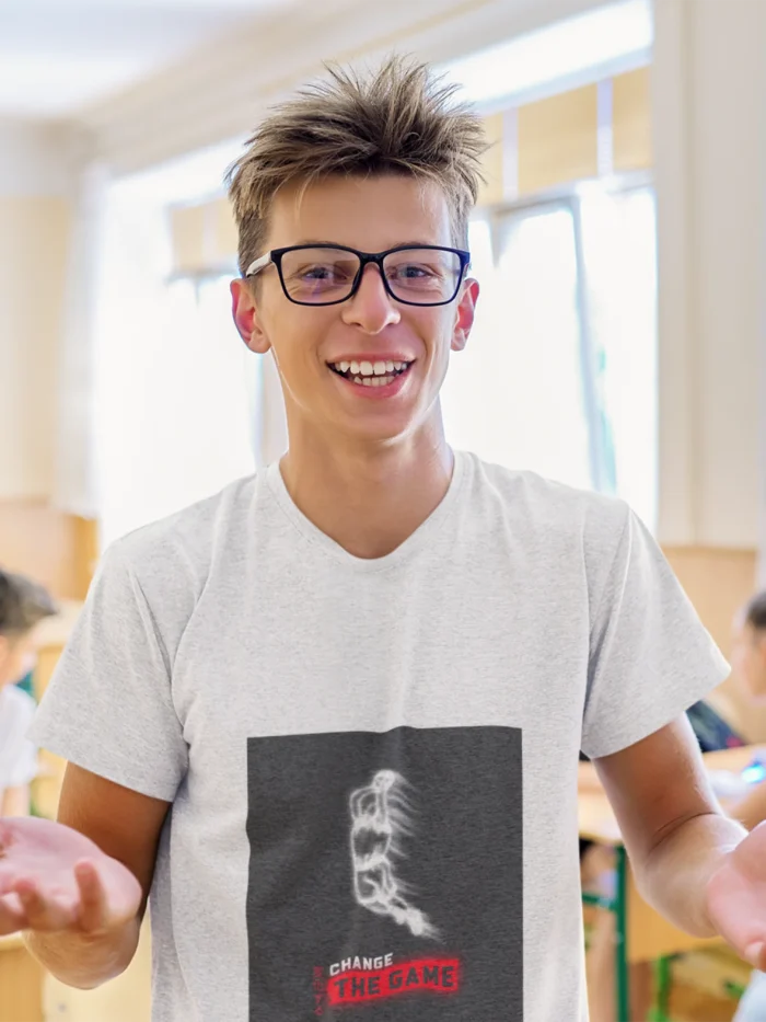 Boy wearing "Change the Game" basketball t-shirt, showcasing bold graphic design and athletic fit.