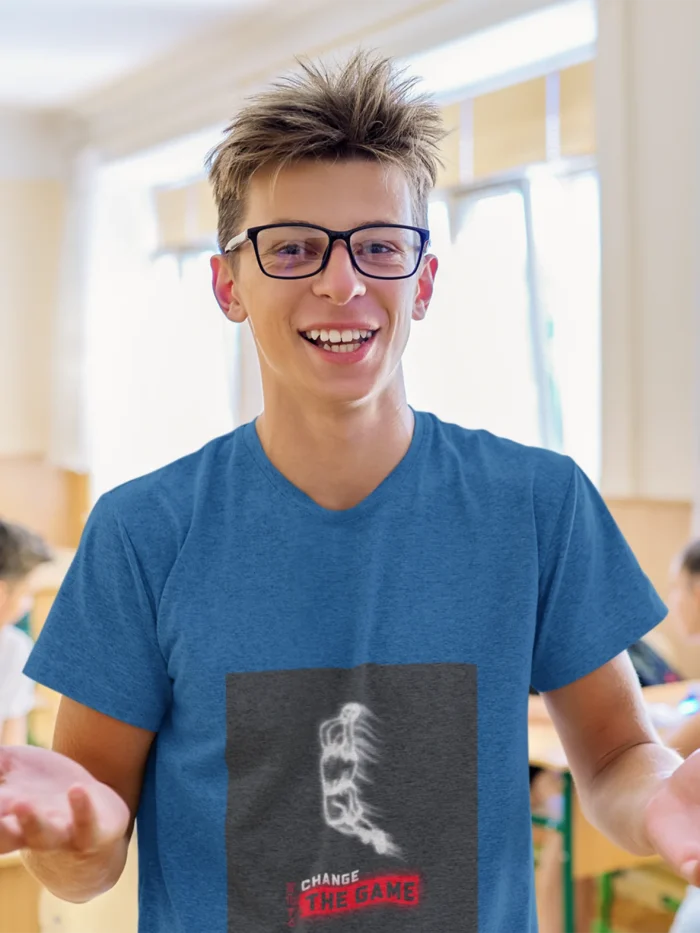 Boy wearing "Change the Game" basketball t-shirt, showcasing bold graphic design and athletic fit.