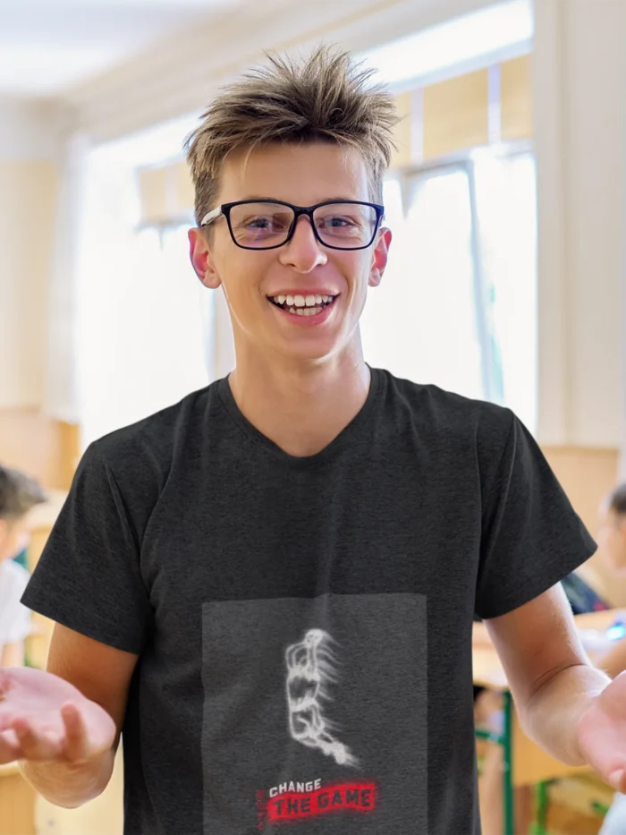 Boy wearing "Change the Game" basketball t-shirt, showcasing bold graphic design and athletic fit.