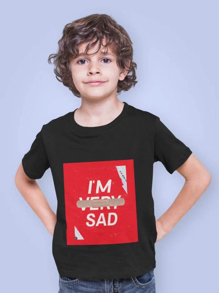 Boy wearing an "I'm Sad" graphic t-shirt with bold text design, expressing an emotional yet trendy statement.