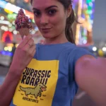 Girls wearing a "Jurassic Roar Adventures" t-shirt with a colorful dinosaur design.