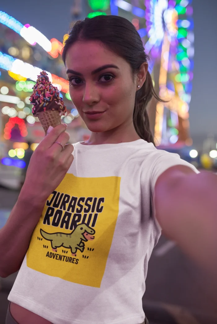 Girls wearing a "Jurassic Roar Adventures" t-shirt with a colorful dinosaur design.